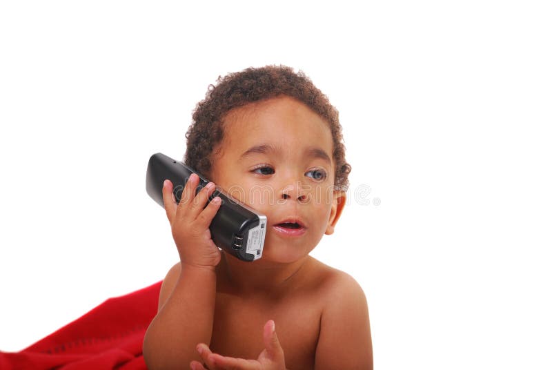 A multi-racial baby boy wrapped in a red blanket playing with a telephone. A multi-racial baby boy wrapped in a red blanket playing with a telephone.