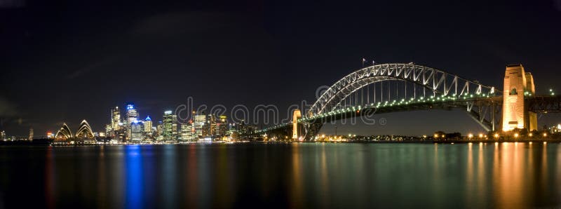 Sydney Harbour Sky Line At Night, NSW, Australia, Oceania. The Sydney harbour bridge and sydney opera house sparkling in the night. Colourful surface. Night scene, panorama. Sydney Harbour Sky Line At Night, NSW, Australia, Oceania. The Sydney harbour bridge and sydney opera house sparkling in the night. Colourful surface. Night scene, panorama
