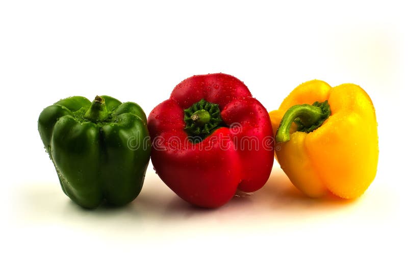 Green, yellow and red sweet peppers in a line with water drops isolated on white background. Green, yellow and red sweet peppers in a line with water drops isolated on white background