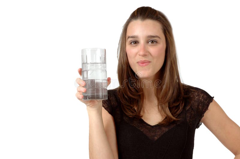 Woman enjoys her glass of ice water. Woman enjoys her glass of ice water.