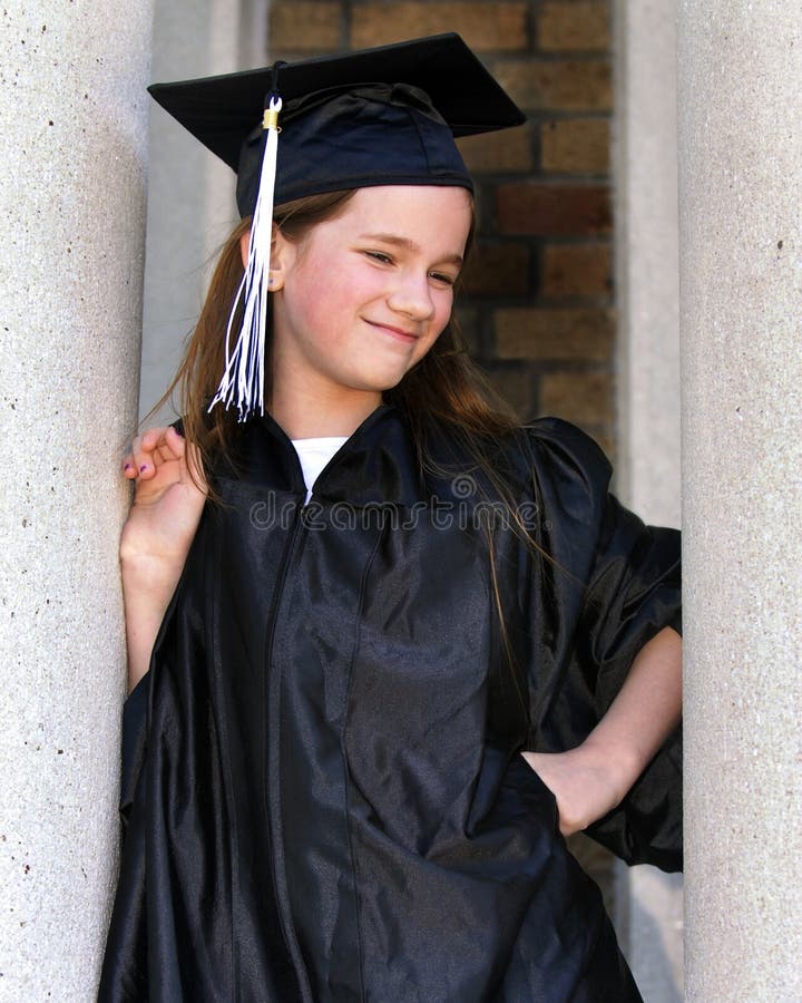 A middle school grad with attitude between the pillars of her school. A middle school grad with attitude between the pillars of her school