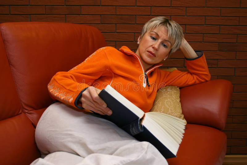 Reading woman on a red sofa. Reading woman on a red sofa