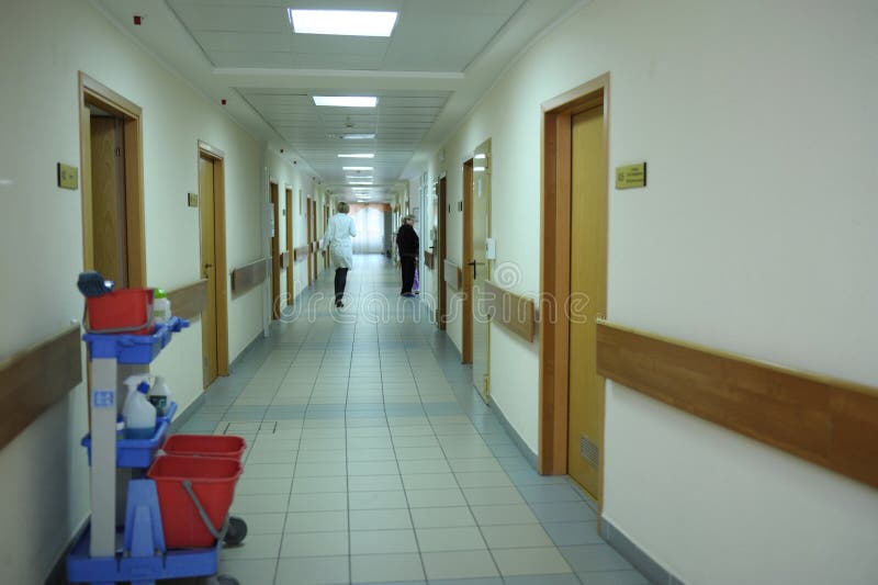 Woman doctor in white lab coat walking the corridor of a hospital. February 2, 2020. Kyiv, Ukraine. Woman doctor in white lab coat walking the corridor of a hospital. February 2, 2020. Kyiv, Ukraine