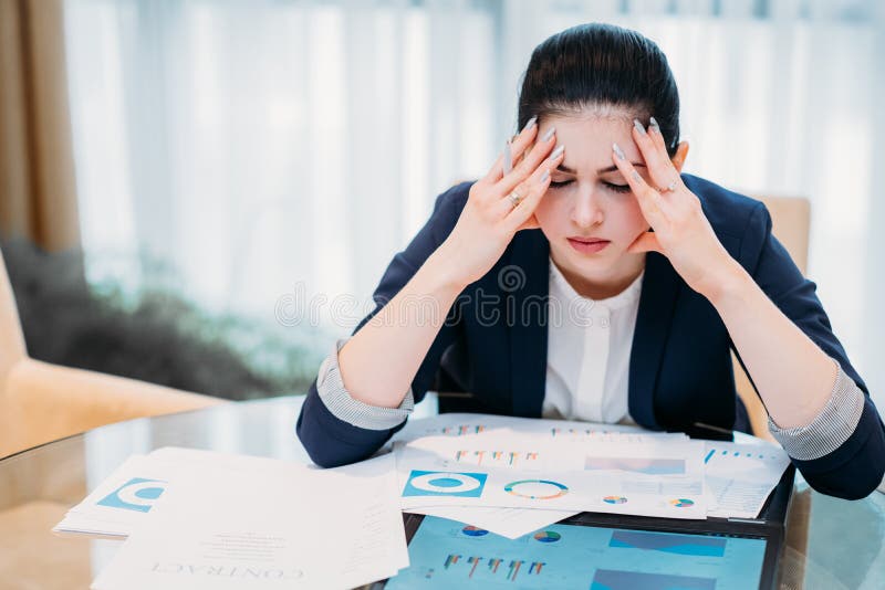 Stress headache and fatigue. business career downfalls. tired woman sitting in office her eyes closed. Stress headache and fatigue. business career downfalls. tired woman sitting in office her eyes closed