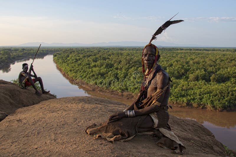 The Karo, or Kara, are a Nilotic ethnic group in Ethiopia famous for their body painting. They are also one of the smallest tribes in the region with an estimated population of 1.000-1.200 people. They are closely related to their neighbors, Hamer and Banna, with a lexical similarity of 81 They live along the east banks of the Omo River in southern Ethiopia and survive on agriculture and natural annual flooding. They have had the same culture and traditions for 500 years, like traditional dancing and painting their bodies with a mix of ash and fat or water.The Karo people differentiate themselves from many of the neighbouring tribes by excelling specifically in body and face painting. They paint themselves daily with coloured ochre, white chalk, yellow mineral rock, charcoal, and pulverized iron ore, all natural resources local to the area. The specific designs drawn on their bodies can change daily and vary in content, ranging from simple stars or lines to animal motifs, such as guinea fowl plumage, or to the most popular – a myriad of handprints covering the torso and legs. Both the Karo and the Hamar men use clay to construct elaborate hairstyles and headdresses for themselves, signifying status, beauty, and bravery.The photo is part of the album `SECOND ETHIOPIAN TRIBES EXPEDITION`. The Karo, or Kara, are a Nilotic ethnic group in Ethiopia famous for their body painting. They are also one of the smallest tribes in the region with an estimated population of 1.000-1.200 people. They are closely related to their neighbors, Hamer and Banna, with a lexical similarity of 81 They live along the east banks of the Omo River in southern Ethiopia and survive on agriculture and natural annual flooding. They have had the same culture and traditions for 500 years, like traditional dancing and painting their bodies with a mix of ash and fat or water.The Karo people differentiate themselves from many of the neighbouring tribes by excelling specifically in body and face painting. They paint themselves daily with coloured ochre, white chalk, yellow mineral rock, charcoal, and pulverized iron ore, all natural resources local to the area. The specific designs drawn on their bodies can change daily and vary in content, ranging from simple stars or lines to animal motifs, such as guinea fowl plumage, or to the most popular – a myriad of handprints covering the torso and legs. Both the Karo and the Hamar men use clay to construct elaborate hairstyles and headdresses for themselves, signifying status, beauty, and bravery.The photo is part of the album `SECOND ETHIOPIAN TRIBES EXPEDITION`