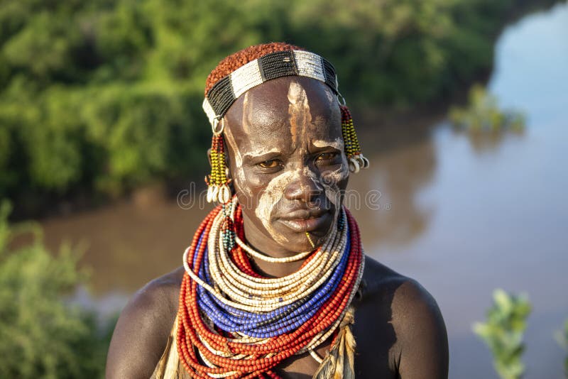 The Karo, or Kara, are a Nilotic ethnic group in Ethiopia famous for their body painting. They are also one of the smallest tribes in the region with an estimated population of 1.000-1.200 people. They are closely related to their neighbors, Hamer and Banna, with a lexical similarity of 81 They live along the east banks of the Omo River in southern Ethiopia and survive on agriculture and natural annual flooding. They have had the same culture and traditions for 500 years, like traditional dancing and painting their bodies with a mix of ash and fat or water.The Karo people differentiate themselves from many of the neighbouring tribes by excelling specifically in body and face painting. They paint themselves daily with coloured ochre, white chalk, yellow mineral rock, charcoal, and pulverized iron ore, all natural resources local to the area. The specific designs drawn on their bodies can change daily and vary in content, ranging from simple stars or lines to animal motifs, such as guinea fowl plumage, or to the most popular – a myriad of handprints covering the torso and legs. Both the Karo and the Hamar men use clay to construct elaborate hairstyles and headdresses for themselves, signifying status, beauty, and bravery.The photo is part of the album `SECOND ETHIOPIAN TRIBES EXPEDITION`. The Karo, or Kara, are a Nilotic ethnic group in Ethiopia famous for their body painting. They are also one of the smallest tribes in the region with an estimated population of 1.000-1.200 people. They are closely related to their neighbors, Hamer and Banna, with a lexical similarity of 81 They live along the east banks of the Omo River in southern Ethiopia and survive on agriculture and natural annual flooding. They have had the same culture and traditions for 500 years, like traditional dancing and painting their bodies with a mix of ash and fat or water.The Karo people differentiate themselves from many of the neighbouring tribes by excelling specifically in body and face painting. They paint themselves daily with coloured ochre, white chalk, yellow mineral rock, charcoal, and pulverized iron ore, all natural resources local to the area. The specific designs drawn on their bodies can change daily and vary in content, ranging from simple stars or lines to animal motifs, such as guinea fowl plumage, or to the most popular – a myriad of handprints covering the torso and legs. Both the Karo and the Hamar men use clay to construct elaborate hairstyles and headdresses for themselves, signifying status, beauty, and bravery.The photo is part of the album `SECOND ETHIOPIAN TRIBES EXPEDITION`