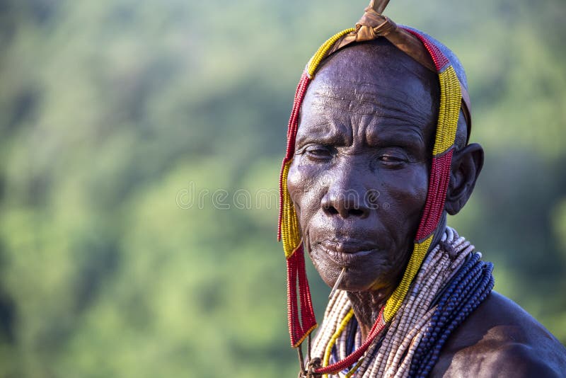 The Karo, or Kara, are a Nilotic ethnic group in Ethiopia famous for their body painting. They are also one of the smallest tribes in the region with an estimated population of 1.000-1.200 people. They are closely related to their neighbors, Hamer and Banna, with a lexical similarity of 81 They live along the east banks of the Omo River in southern Ethiopia and survive on agriculture and natural annual flooding. They have had the same culture and traditions for 500 years, like traditional dancing and painting their bodies with a mix of ash and fat or water.The Karo people differentiate themselves from many of the neighbouring tribes by excelling specifically in body and face painting. They paint themselves daily with coloured ochre, white chalk, yellow mineral rock, charcoal, and pulverized iron ore, all natural resources local to the area. The specific designs drawn on their bodies can change daily and vary in content, ranging from simple stars or lines to animal motifs, such as guinea fowl plumage, or to the most popular – a myriad of handprints covering the torso and legs. Both the Karo and the Hamar men use clay to construct elaborate hairstyles and headdresses for themselves, signifying status, beauty, and bravery.The photo is part of the album `SECOND ETHIOPIAN TRIBES EXPEDITION`. The Karo, or Kara, are a Nilotic ethnic group in Ethiopia famous for their body painting. They are also one of the smallest tribes in the region with an estimated population of 1.000-1.200 people. They are closely related to their neighbors, Hamer and Banna, with a lexical similarity of 81 They live along the east banks of the Omo River in southern Ethiopia and survive on agriculture and natural annual flooding. They have had the same culture and traditions for 500 years, like traditional dancing and painting their bodies with a mix of ash and fat or water.The Karo people differentiate themselves from many of the neighbouring tribes by excelling specifically in body and face painting. They paint themselves daily with coloured ochre, white chalk, yellow mineral rock, charcoal, and pulverized iron ore, all natural resources local to the area. The specific designs drawn on their bodies can change daily and vary in content, ranging from simple stars or lines to animal motifs, such as guinea fowl plumage, or to the most popular – a myriad of handprints covering the torso and legs. Both the Karo and the Hamar men use clay to construct elaborate hairstyles and headdresses for themselves, signifying status, beauty, and bravery.The photo is part of the album `SECOND ETHIOPIAN TRIBES EXPEDITION`