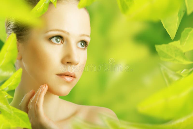 Beauty woman and a natural skin care in herbal green background. Beauty woman and a natural skin care in herbal green background