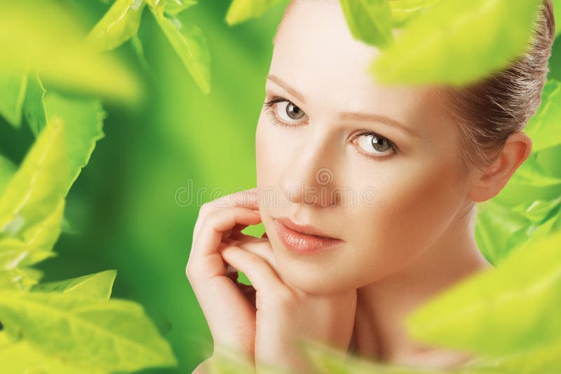 Beauty woman and a natural skin care in herbal green background. Beauty woman and a natural skin care in herbal green background