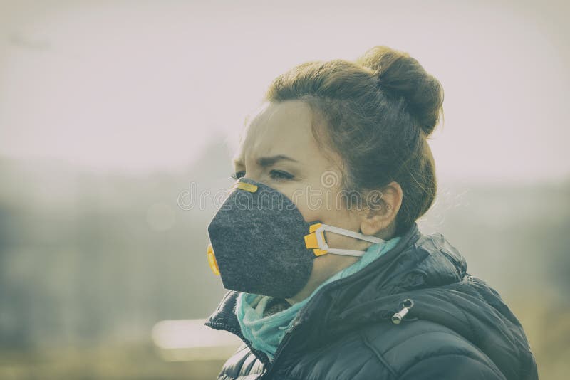 Γυναίκα που φορά μια πραγματική μάσκα κατά της μόλυνσης, ενάντια στο νέφος και προσώπου ιών στοκ φωτογραφίες Γυναίκα που φορά μια πραγματική μάσκα κατά της μόλυνσης, ενάντια στο νέφος και προσώπου ιών στοκ φωτογραφίες
