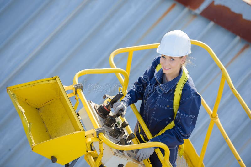 Woman in cherry picker bucket cherry. Woman in cherry picker bucket cherry