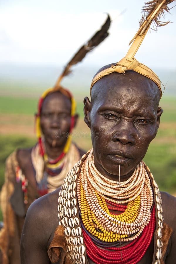 The Karo, or Kara, are a Nilotic ethnic group in Ethiopia famous for their body painting. They are also one of the smallest tribes in the region with an estimated population of 1.000-1.200 people. They are closely related to their neighbors, Hamer and Banna, with a lexical similarity of 81 They live along the east banks of the Omo River in southern Ethiopia and survive on agriculture and natural annual flooding. They have had the same culture and traditions for 500 years, like traditional dancing and painting their bodies with a mix of ash and fat or water.The Karo people differentiate themselves from many of the neighbouring tribes by excelling specifically in body and face painting. They paint themselves daily with coloured ochre, white chalk, yellow mineral rock, charcoal, and pulverized iron ore, all natural resources local to the area. The specific designs drawn on their bodies can change daily and vary in content, ranging from simple stars or lines to animal motifs, such as guinea fowl plumage, or to the most popular – a myriad of handprints covering the torso and legs. Both the Karo and the Hamar men use clay to construct elaborate hairstyles and headdresses for themselves, signifying status, beauty, and bravery.The photo is part of the album `SECOND ETHIOPIAN TRIBES EXPEDITION`. The Karo, or Kara, are a Nilotic ethnic group in Ethiopia famous for their body painting. They are also one of the smallest tribes in the region with an estimated population of 1.000-1.200 people. They are closely related to their neighbors, Hamer and Banna, with a lexical similarity of 81 They live along the east banks of the Omo River in southern Ethiopia and survive on agriculture and natural annual flooding. They have had the same culture and traditions for 500 years, like traditional dancing and painting their bodies with a mix of ash and fat or water.The Karo people differentiate themselves from many of the neighbouring tribes by excelling specifically in body and face painting. They paint themselves daily with coloured ochre, white chalk, yellow mineral rock, charcoal, and pulverized iron ore, all natural resources local to the area. The specific designs drawn on their bodies can change daily and vary in content, ranging from simple stars or lines to animal motifs, such as guinea fowl plumage, or to the most popular – a myriad of handprints covering the torso and legs. Both the Karo and the Hamar men use clay to construct elaborate hairstyles and headdresses for themselves, signifying status, beauty, and bravery.The photo is part of the album `SECOND ETHIOPIAN TRIBES EXPEDITION`