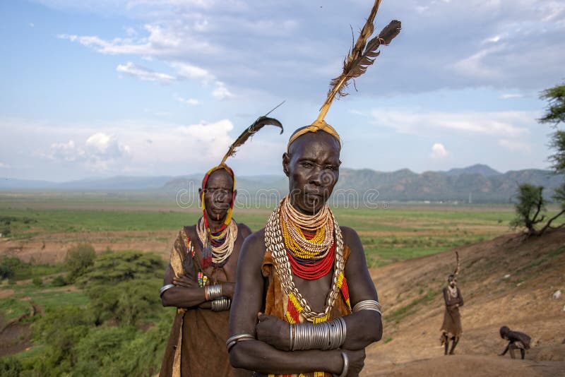 The Karo, or Kara, are a Nilotic ethnic group in Ethiopia famous for their body painting. They are also one of the smallest tribes in the region with an estimated population of 1.000-1.200 people. They are closely related to their neighbors, Hamer and Banna, with a lexical similarity of 81 They live along the east banks of the Omo River in southern Ethiopia and survive on agriculture and natural annual flooding. They have had the same culture and traditions for 500 years, like traditional dancing and painting their bodies with a mix of ash and fat or water.The Karo people differentiate themselves from many of the neighbouring tribes by excelling specifically in body and face painting. They paint themselves daily with coloured ochre, white chalk, yellow mineral rock, charcoal, and pulverized iron ore, all natural resources local to the area. The specific designs drawn on their bodies can change daily and vary in content, ranging from simple stars or lines to animal motifs, such as guinea fowl plumage, or to the most popular – a myriad of handprints covering the torso and legs. Both the Karo and the Hamar men use clay to construct elaborate hairstyles and headdresses for themselves, signifying status, beauty, and bravery.The photo is part of the album `SECOND ETHIOPIAN TRIBES EXPEDITION`. The Karo, or Kara, are a Nilotic ethnic group in Ethiopia famous for their body painting. They are also one of the smallest tribes in the region with an estimated population of 1.000-1.200 people. They are closely related to their neighbors, Hamer and Banna, with a lexical similarity of 81 They live along the east banks of the Omo River in southern Ethiopia and survive on agriculture and natural annual flooding. They have had the same culture and traditions for 500 years, like traditional dancing and painting their bodies with a mix of ash and fat or water.The Karo people differentiate themselves from many of the neighbouring tribes by excelling specifically in body and face painting. They paint themselves daily with coloured ochre, white chalk, yellow mineral rock, charcoal, and pulverized iron ore, all natural resources local to the area. The specific designs drawn on their bodies can change daily and vary in content, ranging from simple stars or lines to animal motifs, such as guinea fowl plumage, or to the most popular – a myriad of handprints covering the torso and legs. Both the Karo and the Hamar men use clay to construct elaborate hairstyles and headdresses for themselves, signifying status, beauty, and bravery.The photo is part of the album `SECOND ETHIOPIAN TRIBES EXPEDITION`