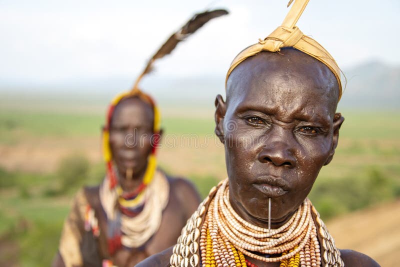 The Karo, or Kara, are a Nilotic ethnic group in Ethiopia famous for their body painting. They are also one of the smallest tribes in the region with an estimated population of 1.000-1.200 people. They are closely related to their neighbors, Hamer and Banna, with a lexical similarity of 81 They live along the east banks of the Omo River in southern Ethiopia and survive on agriculture and natural annual flooding. They have had the same culture and traditions for 500 years, like traditional dancing and painting their bodies with a mix of ash and fat or water.The Karo people differentiate themselves from many of the neighbouring tribes by excelling specifically in body and face painting. They paint themselves daily with coloured ochre, white chalk, yellow mineral rock, charcoal, and pulverized iron ore, all natural resources local to the area. The specific designs drawn on their bodies can change daily and vary in content, ranging from simple stars or lines to animal motifs, such as guinea fowl plumage, or to the most popular – a myriad of handprints covering the torso and legs. Both the Karo and the Hamar men use clay to construct elaborate hairstyles and headdresses for themselves, signifying status, beauty, and bravery.The photo is part of the album `SECOND ETHIOPIAN TRIBES EXPEDITION`. The Karo, or Kara, are a Nilotic ethnic group in Ethiopia famous for their body painting. They are also one of the smallest tribes in the region with an estimated population of 1.000-1.200 people. They are closely related to their neighbors, Hamer and Banna, with a lexical similarity of 81 They live along the east banks of the Omo River in southern Ethiopia and survive on agriculture and natural annual flooding. They have had the same culture and traditions for 500 years, like traditional dancing and painting their bodies with a mix of ash and fat or water.The Karo people differentiate themselves from many of the neighbouring tribes by excelling specifically in body and face painting. They paint themselves daily with coloured ochre, white chalk, yellow mineral rock, charcoal, and pulverized iron ore, all natural resources local to the area. The specific designs drawn on their bodies can change daily and vary in content, ranging from simple stars or lines to animal motifs, such as guinea fowl plumage, or to the most popular – a myriad of handprints covering the torso and legs. Both the Karo and the Hamar men use clay to construct elaborate hairstyles and headdresses for themselves, signifying status, beauty, and bravery.The photo is part of the album `SECOND ETHIOPIAN TRIBES EXPEDITION`