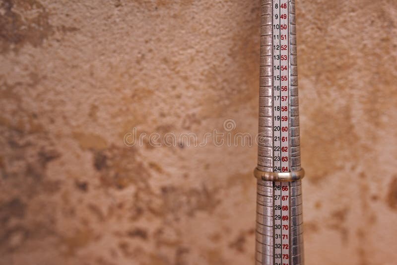 Horizontal view of a ring strung on ring mandrel in a goldsmith`s workshop. Horizontal view of a ring strung on ring mandrel in a goldsmith`s workshop.