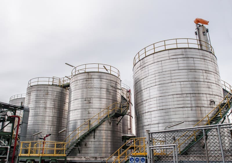 Storage tanks in oil refinery with cloudy sky. Storage tanks in oil refinery with cloudy sky