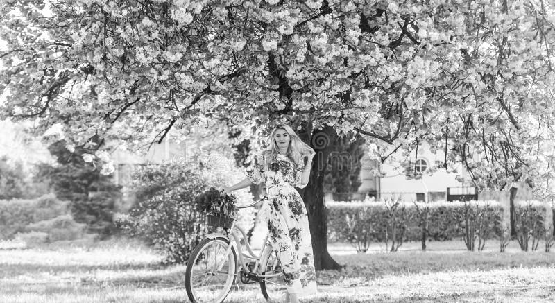 διάθεση. κορίτσι με μηχανή εποχής. δέντρο sakura. καλοκαιρινή μόδα και ομορφιά. κυρία περπατάει στο πάρκο. ροζ κεράσι στοκ φωτογραφία με δικαίωμα ελεύθερης χρήσης