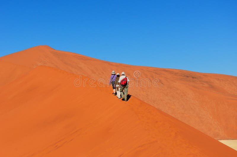 People walking on beautiful dune of Namib desert, traveling and hiking in South Africa. People walking on beautiful dune of Namib desert, traveling and hiking in South Africa