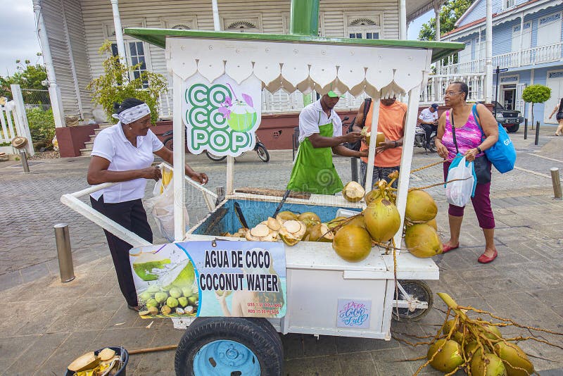 A street vendor in Puerto Plata, Dominican Republic is selling fresh coconut water to tourists and locals alike. Many residents make they financial living this way. A street vendor in Puerto Plata, Dominican Republic is selling fresh coconut water to tourists and locals alike. Many residents make they financial living this way.