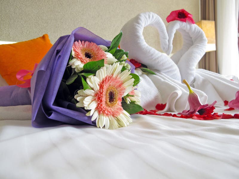 Two swans made of towels and Bridal bouquets in hotel's honeymoon room. Two swans made of towels and Bridal bouquets in hotel's honeymoon room.