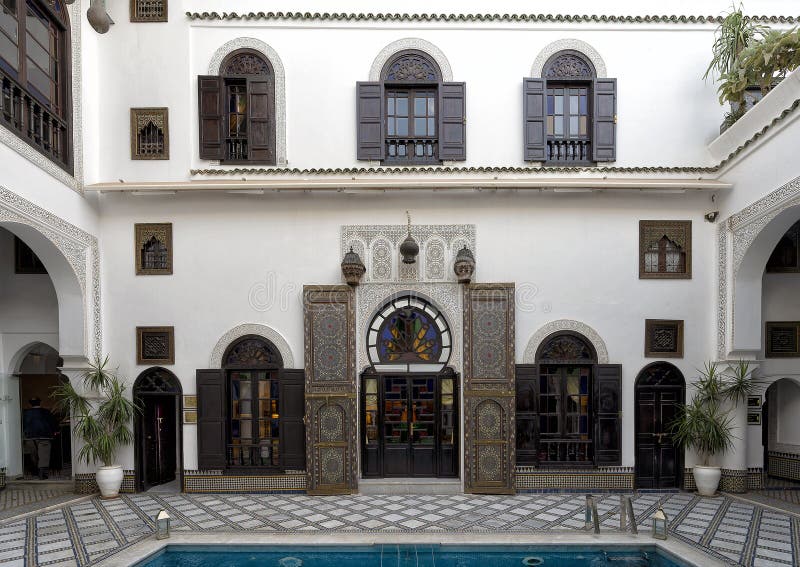 Pictured is the entrance to a room in the courtyard with pool at the Riad Maison Bleue in in Fes, Morocco. Riad Maison Bleue was created in a house dating from the 19th century whose former owner, was the late Moulay Bel Arbi El Alaoui, famous judge and professor of theology.  Today it is managed by the El Abbadi`s family. Pictured is the entrance to a room in the courtyard with pool at the Riad Maison Bleue in in Fes, Morocco. Riad Maison Bleue was created in a house dating from the 19th century whose former owner, was the late Moulay Bel Arbi El Alaoui, famous judge and professor of theology.  Today it is managed by the El Abbadi`s family.