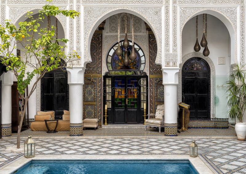 Pictured is the entrance to a room in the courtyard with pool at the Riad Maison Bleue in in Fes, Morocco. Riad Maison Bleue was created in a house dating from the 19th century whose former owner, was the late Moulay Bel Arbi El Alaoui, famous judge and professor of theology.  Today it is managed by the El Abbadi`s family. Pictured is the entrance to a room in the courtyard with pool at the Riad Maison Bleue in in Fes, Morocco. Riad Maison Bleue was created in a house dating from the 19th century whose former owner, was the late Moulay Bel Arbi El Alaoui, famous judge and professor of theology.  Today it is managed by the El Abbadi`s family.