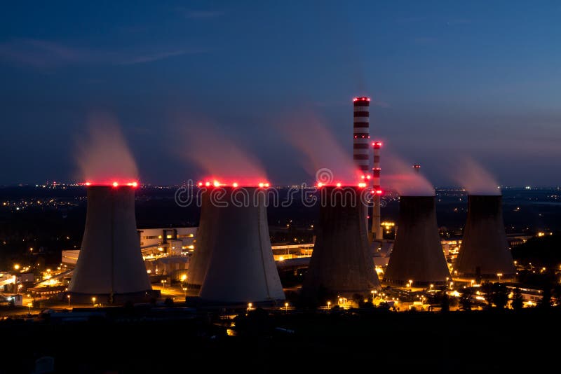 Night scene with huge nuclear power plant. Smokestacks illuminated with red lamps making blurred effect on smoke. Night scene with huge nuclear power plant. Smokestacks illuminated with red lamps making blurred effect on smoke.