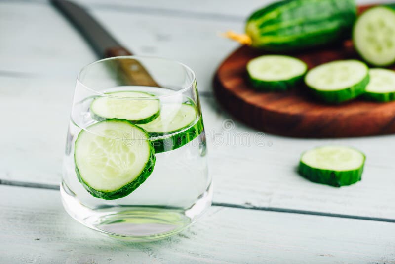 Infused water with sliced cucumber in a drinking glass. Infused water with sliced cucumber in a drinking glass