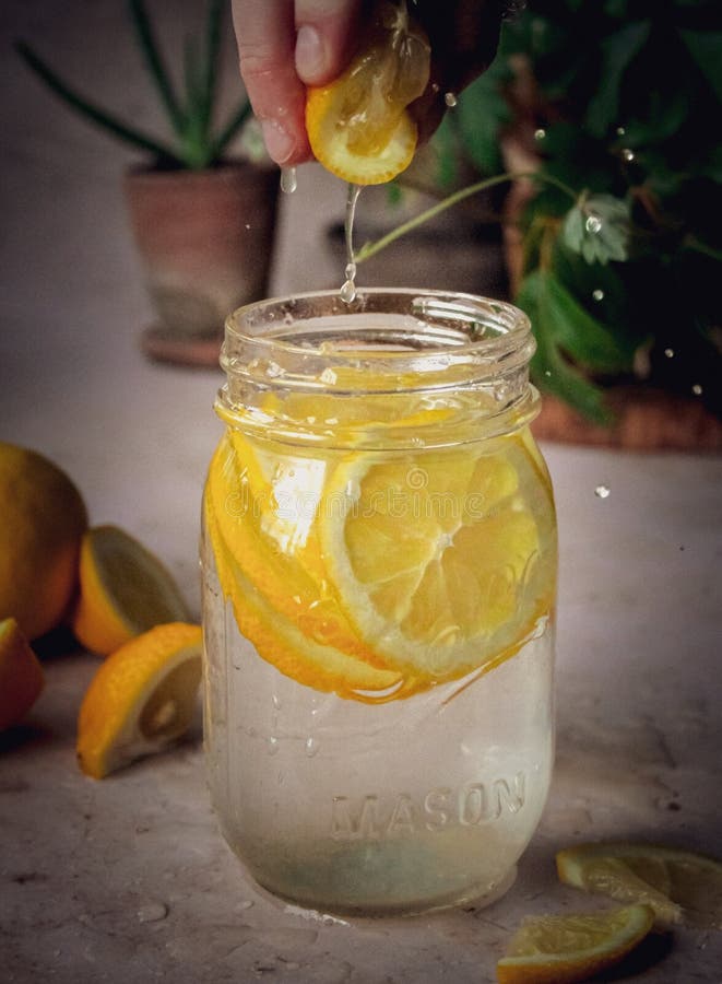 An infused water with lemon slices in a jar. An infused water with lemon slices in a jar