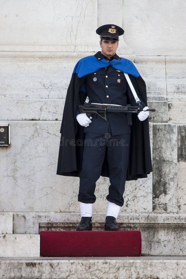 Guard Ceremonial Altar of the Fatherland in Rome (Victorian) with rifle. The guard of honor has a gun in his hand and a cloak and controls the shrine of the Unknown Soldier. Guard Ceremonial Altar of the Fatherland in Rome (Victorian) with rifle. The guard of honor has a gun in his hand and a cloak and controls the shrine of the Unknown Soldier.
