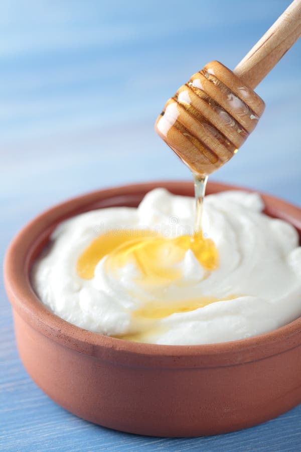 Greek yogurt with honey in a pot. Greek yogurt with honey in a pot