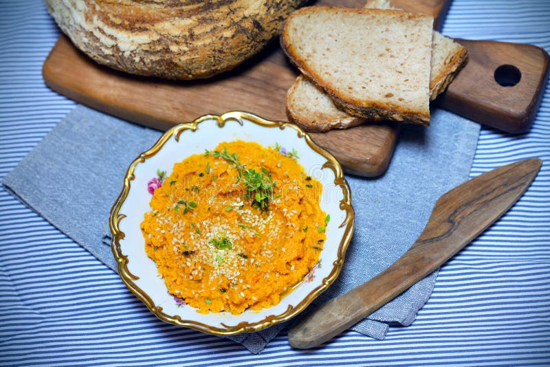 Carrot and pumpkin dip, spread with sourdough bread, snack or breakfast, healthy choice. Carrot and pumpkin dip, spread with sourdough bread, snack or breakfast, healthy choice