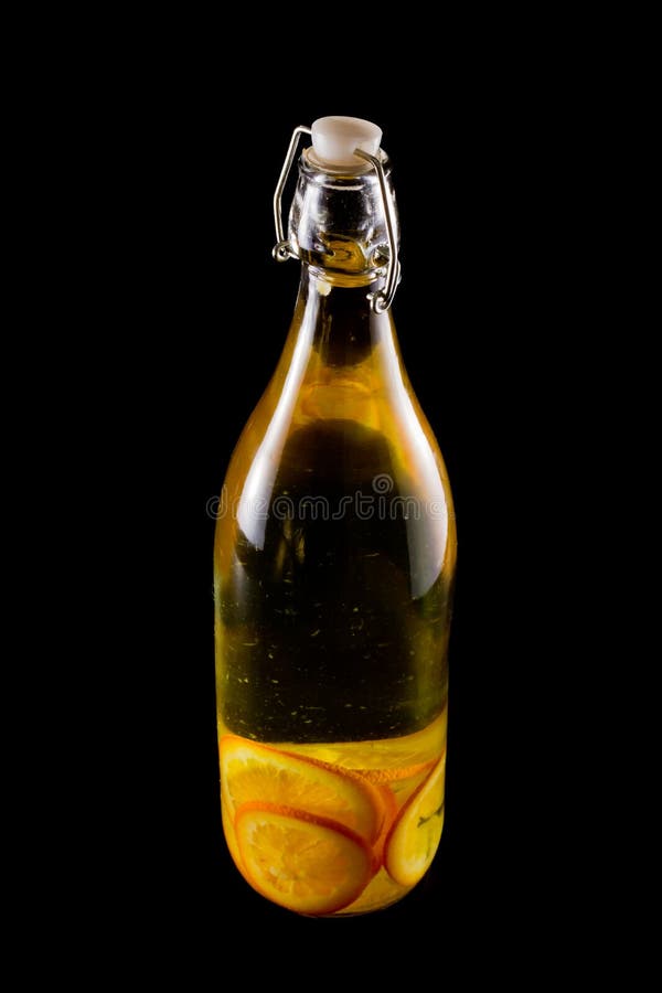 Orange infused vodka bottle on a dark black background. Orange infused vodka bottle on a dark black background