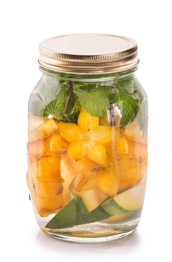 Summer fresh fruit Flavored infused water mix of mango, starfruit and mint isolated over white background. Summer fresh fruit Flavored infused water mix of mango, starfruit and mint isolated over white background