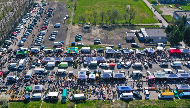 Aerial view on flea market with miscellaneous items and crowds of buyers and seller`s makeshift stands. Aerial view on flea market with miscellaneous items and crowds of buyers and seller`s makeshift stands.