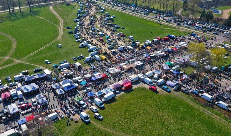 Aerial view on flea market with miscellaneous items and crowds of buyers and seller`s makeshift stands. Aerial view on flea market with miscellaneous items and crowds of buyers and seller`s makeshift stands.