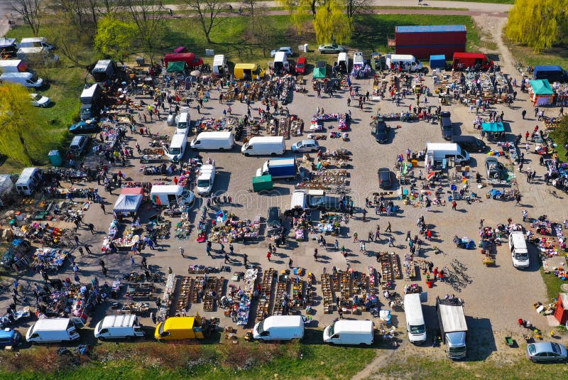 Aerial view on flea market with miscellaneous items and crowds of buyers and seller`s makeshift stands. Aerial view on flea market with miscellaneous items and crowds of buyers and seller`s makeshift stands.