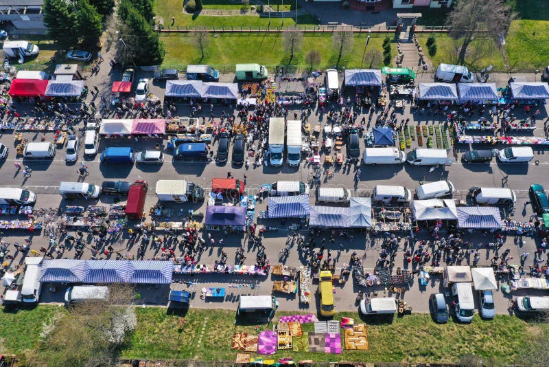 Aerial view on flea market with miscellaneous items and crowds of buyers and seller`s makeshift stands. Aerial view on flea market with miscellaneous items and crowds of buyers and seller`s makeshift stands.