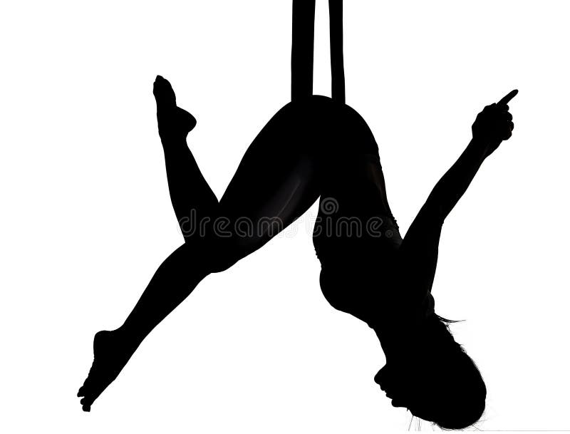 Aerial silk dancing yoga fly in silhouette. Aerial silk dancing yoga fly in silhouette