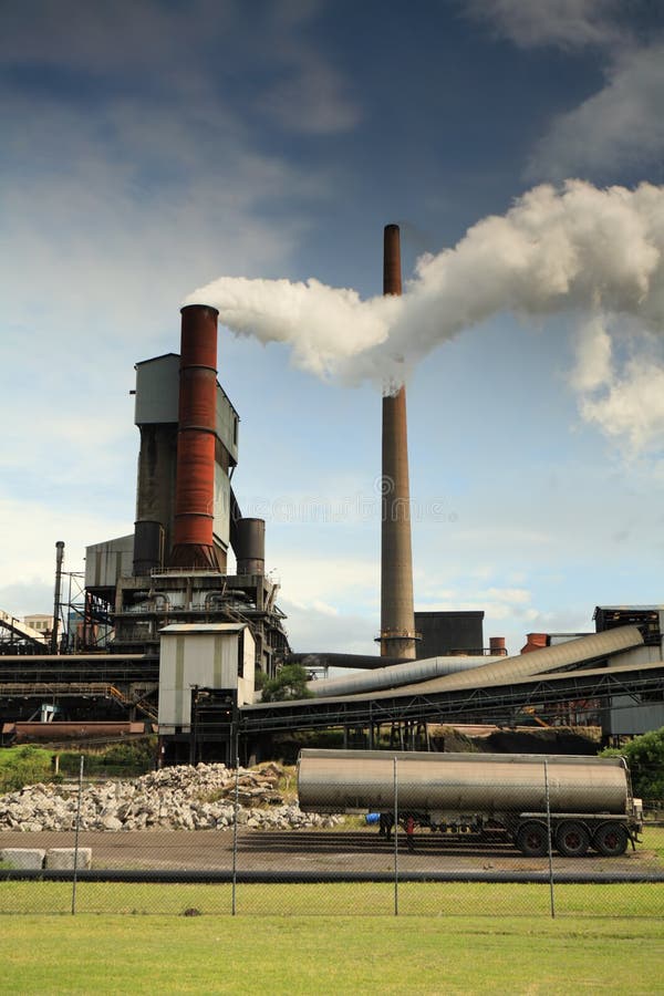 Steel mill smelter emitting toxic fumes and air pollutants billowing up and out of one of its many tall chimneys. Pollutants can vary and include hydrogen fluoride, sulfur dioxide, oxides of nitrogen, offensive and noxious smoke fumes, vapors, gases, and other toxins. A variety of heavy metals: lead, arsenic, chromium, cadmium, nickel, copper, and zinc are also released by the facilities. Steel mill smelter emitting toxic fumes and air pollutants billowing up and out of one of its many tall chimneys. Pollutants can vary and include hydrogen fluoride, sulfur dioxide, oxides of nitrogen, offensive and noxious smoke fumes, vapors, gases, and other toxins. A variety of heavy metals: lead, arsenic, chromium, cadmium, nickel, copper, and zinc are also released by the facilities.