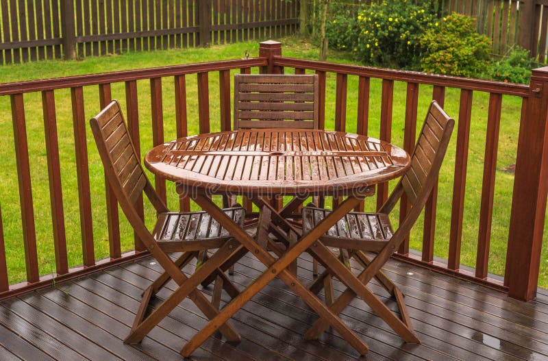 Rain soaked garden table & chairs on a wet day in the UK when summer is over. Easier than photographing a sunny day in the UK. Rain soaked garden table & chairs on a wet day in the UK when summer is over. Easier than photographing a sunny day in the UK.