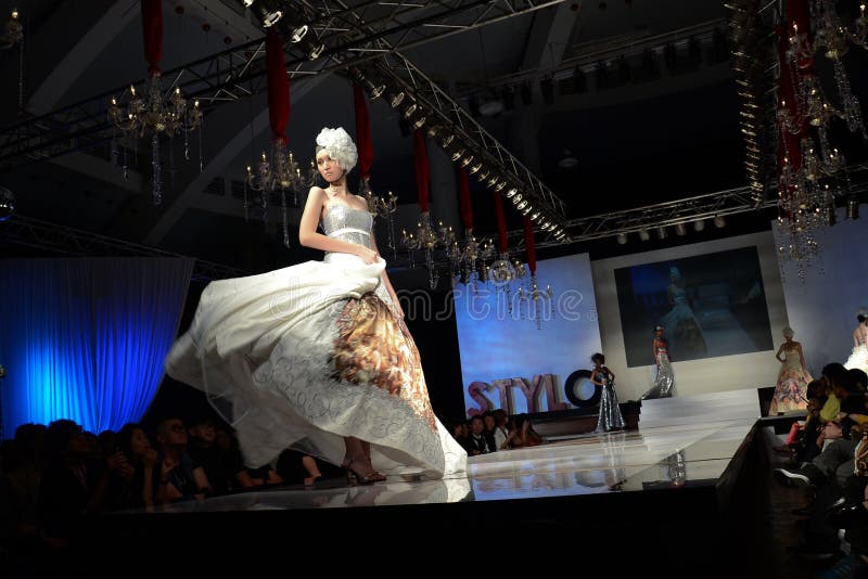 KUALA LUMPUR, MALAYSIA - APRIL 2: A model displays a dress by Dominique Chan during STYLO Fashion Grand Prix at Chin Woo Stadium April 2, 2011 in Kuala Lumpur, Malaysia.The fashion show was held in conjunction with Malaysian F1 Grand Prix. KUALA LUMPUR, MALAYSIA - APRIL 2: A model displays a dress by Dominique Chan during STYLO Fashion Grand Prix at Chin Woo Stadium April 2, 2011 in Kuala Lumpur, Malaysia.The fashion show was held in conjunction with Malaysian F1 Grand Prix.