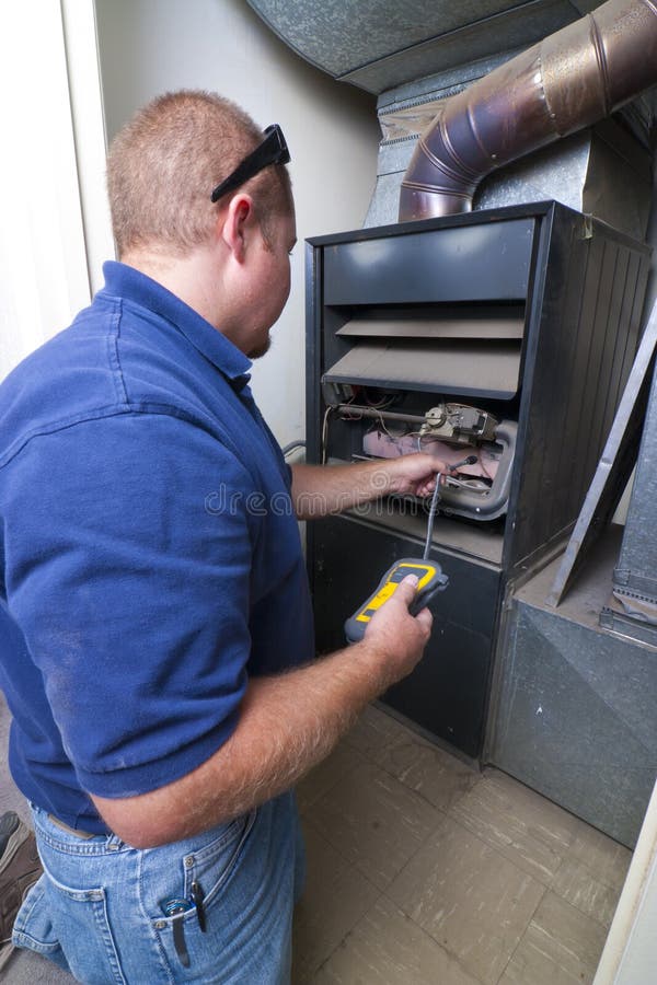 Heater Repair man checking for gas leaks with detector. Heater Repair man checking for gas leaks with detector