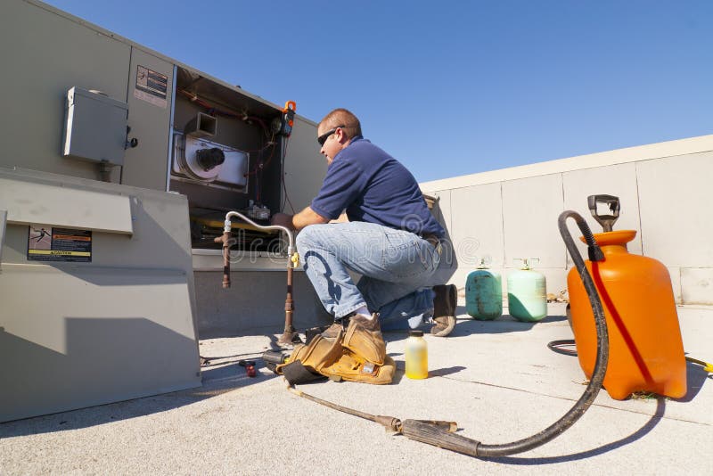 Air Conditioner Repair Man on Roof with Tools and Supplies. Air Conditioner Repair Man on Roof with Tools and Supplies