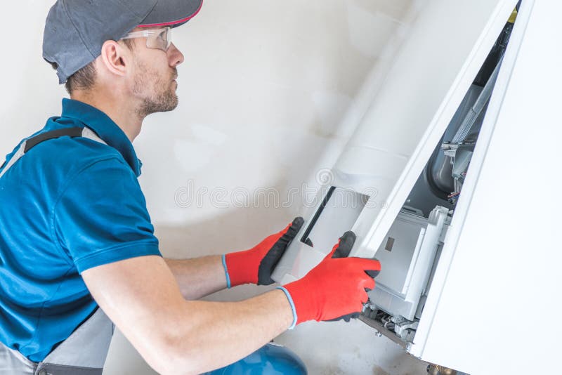 House Heating Unit Repair by Professional Technician. Closeup Photo. Home Equipment Issues. House Heating Unit Repair by Professional Technician. Closeup Photo. Home Equipment Issues