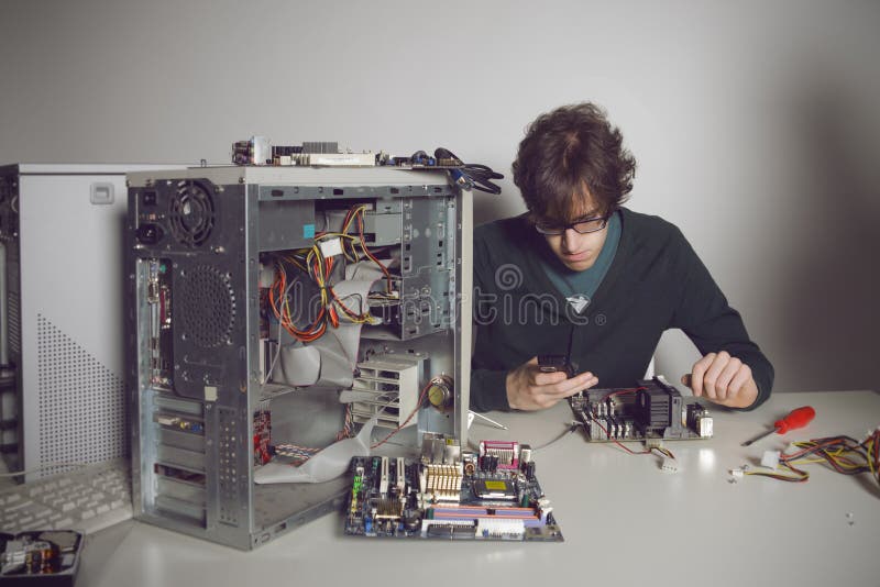 Computer Repair: young man using cellphone. Computer Repair: young man using cellphone