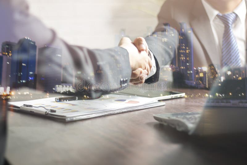 Successful negotiating business concept, Businessmen shaking hands after finishing meeting or setting goals and planning way to success in front of building. Successful negotiating business concept, Businessmen shaking hands after finishing meeting or setting goals and planning way to success in front of building.