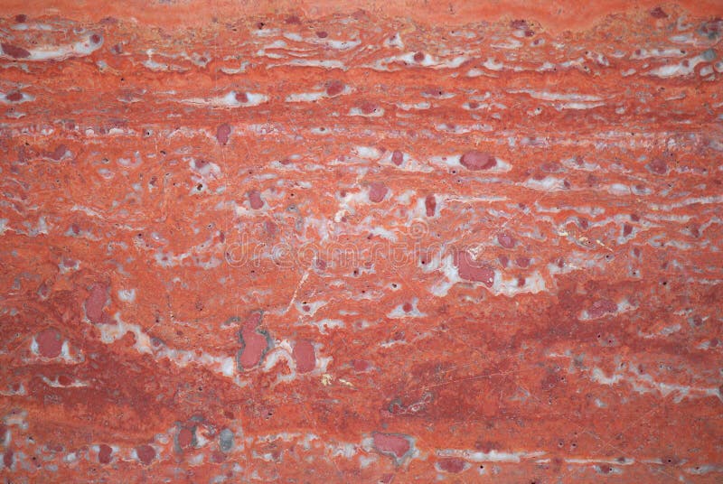 A photo taken on a red granite tile surface on a wall. A photo taken on a red granite tile surface on a wall..