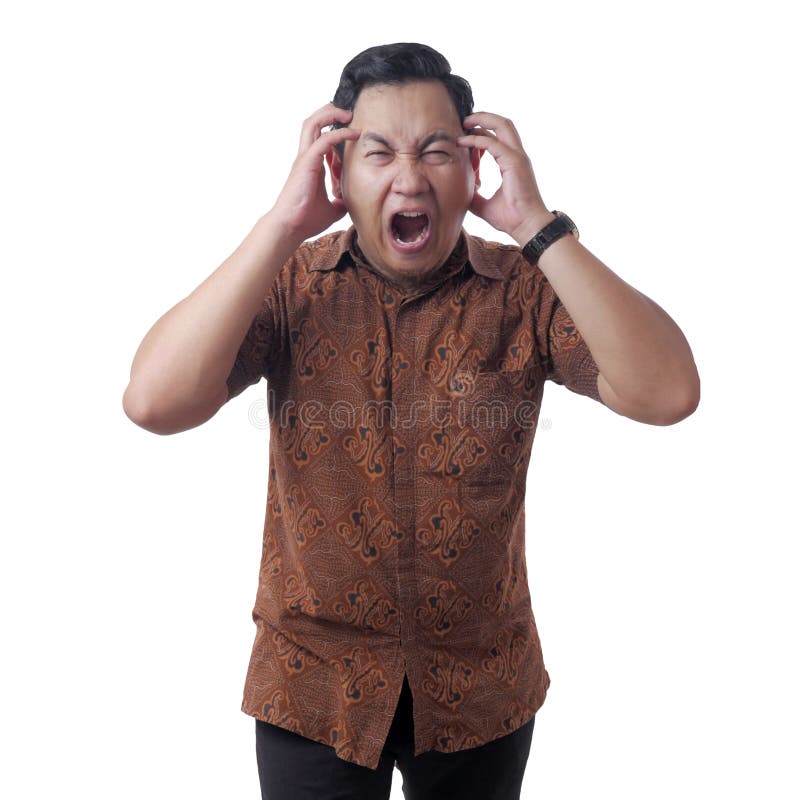 Young Asian businessman in batik shirt looked frustrated having a headache, stress expression. Isolated on white, adult, anger, angry, annoyed, anxious, bad, bankrupt, confused, crazy, depression, disappointed, emotion, face, failure, furious, handsome, human, indonesian, lost, mad, malaysian, male, mature, pain, people, person, portrait, problem, sad, single, tired, unhappy, upset, worry. Young Asian businessman in batik shirt looked frustrated having a headache, stress expression. Isolated on white, adult, anger, angry, annoyed, anxious, bad, bankrupt, confused, crazy, depression, disappointed, emotion, face, failure, furious, handsome, human, indonesian, lost, mad, malaysian, male, mature, pain, people, person, portrait, problem, sad, single, tired, unhappy, upset, worry