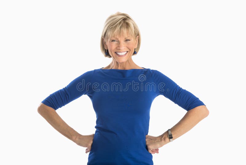 Portrait of happy mature businesswoman with hands on hip standing over white background. Portrait of happy mature businesswoman with hands on hip standing over white background